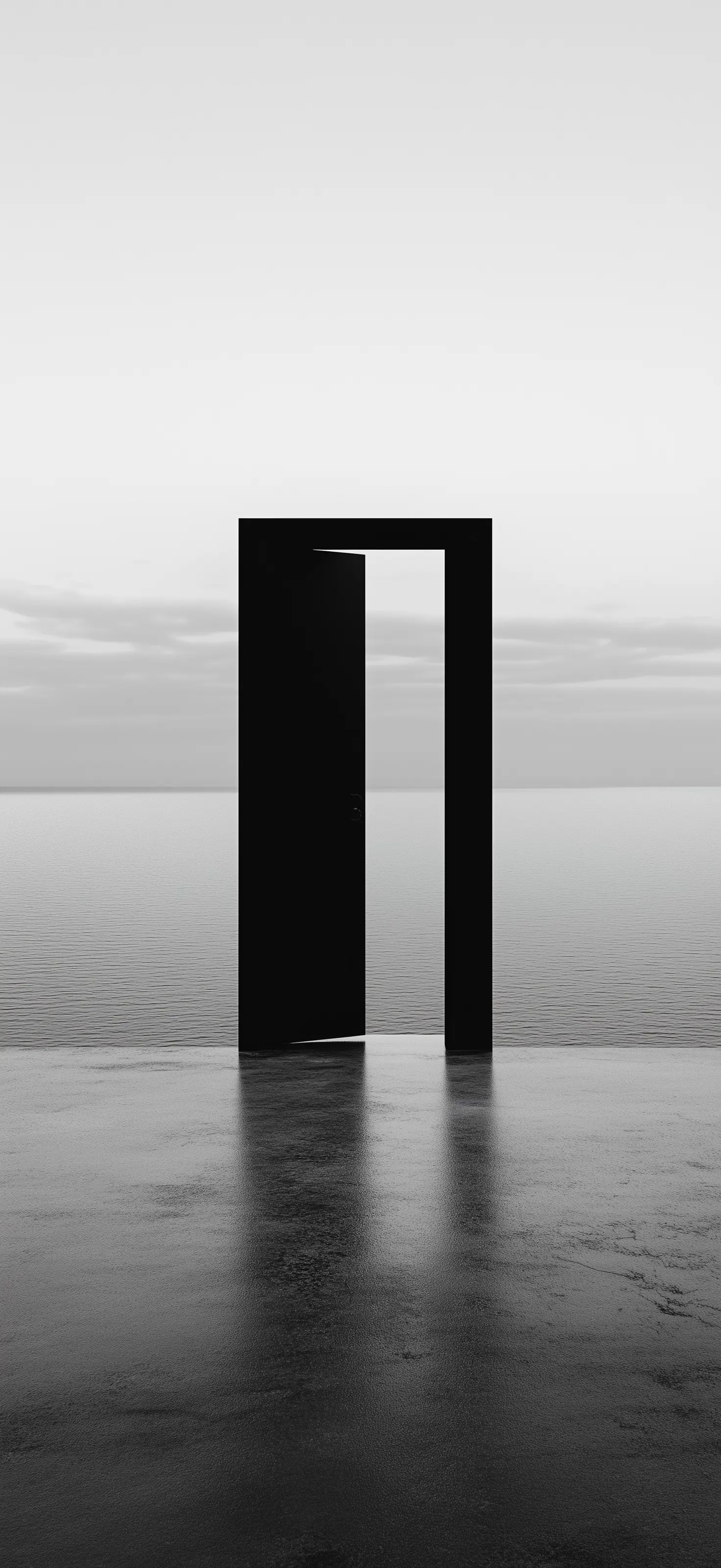 When the world reduces to simplicity, we finally see the real choice: remain in the known gray, or step into undefined emptiness Minimalist black doorway standing alone in reflective water against gray horizon
